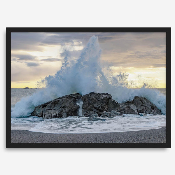 A dramatic fine art beach print showing a huge ocean wave crashing on a beautiful beach in California during sunset