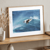 Surfer flying above a turquoise wave in Santa Cruz captured in vibrant ocean photography.