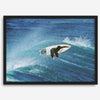 Surfer flying above a turquoise wave in Santa Cruz captured in vibrant ocean photography.