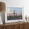Cactus art print of saguaro cacti at sunset with pastel sky over desert landscape.