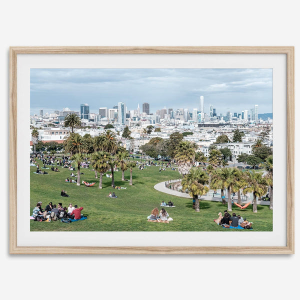 A fine art unframed or framed San Francisco print of Mission Dolores Park showcasing picnic blankets and people enjoying a quiet afternoon with the city skyline in the backdrop.
