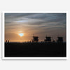 Step into Venice Beach with our fine art beach sunset framed or unframed print. The print showcases the beach in sunset with the silhouettes of the famous lifeguard towers and people in the sunset.