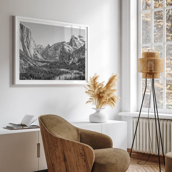 A fine art Yosemite Print featuring Yosemite Valley covered in snow in winter and a beautiful fog lays in the valley forest. This black and white mountain wall art is perfect for nature and fine art lovers.
