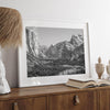 A fine art Yosemite Print featuring Yosemite Valley covered in snow in winter and a beautiful fog lays in the valley forest. This black and white mountain wall art is perfect for nature and fine art lovers.