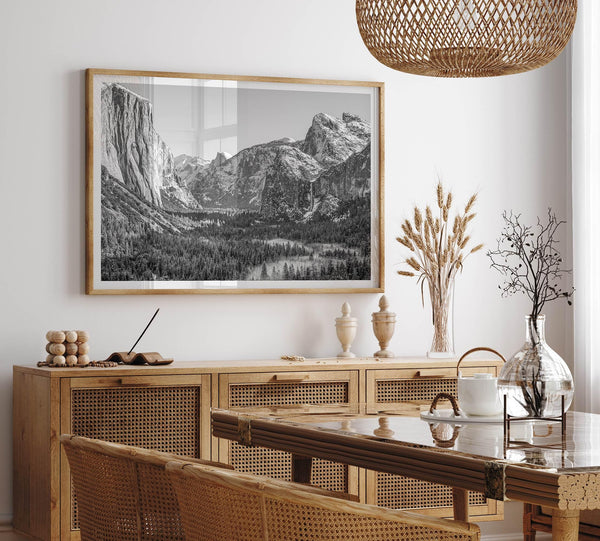 A fine art Yosemite Print featuring Yosemite Valley covered in snow in winter and a beautiful fog lays in the valley forest. This black and white mountain wall art is perfect for nature and fine art lovers.