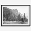 Black and white fine art print of Yosemite National Park in winter with snow-covered trees and granite cliffs.