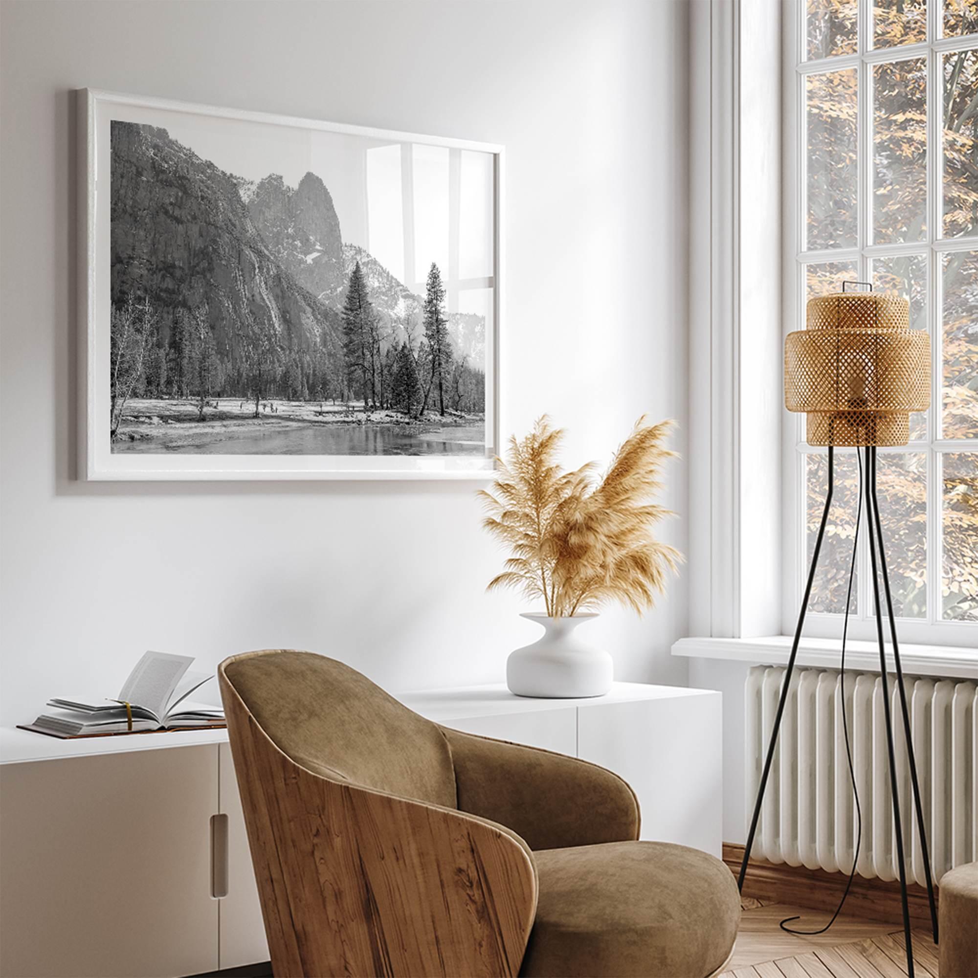 Black and white fine art print of Yosemite National Park in winter with snow-covered trees and granite cliffs.