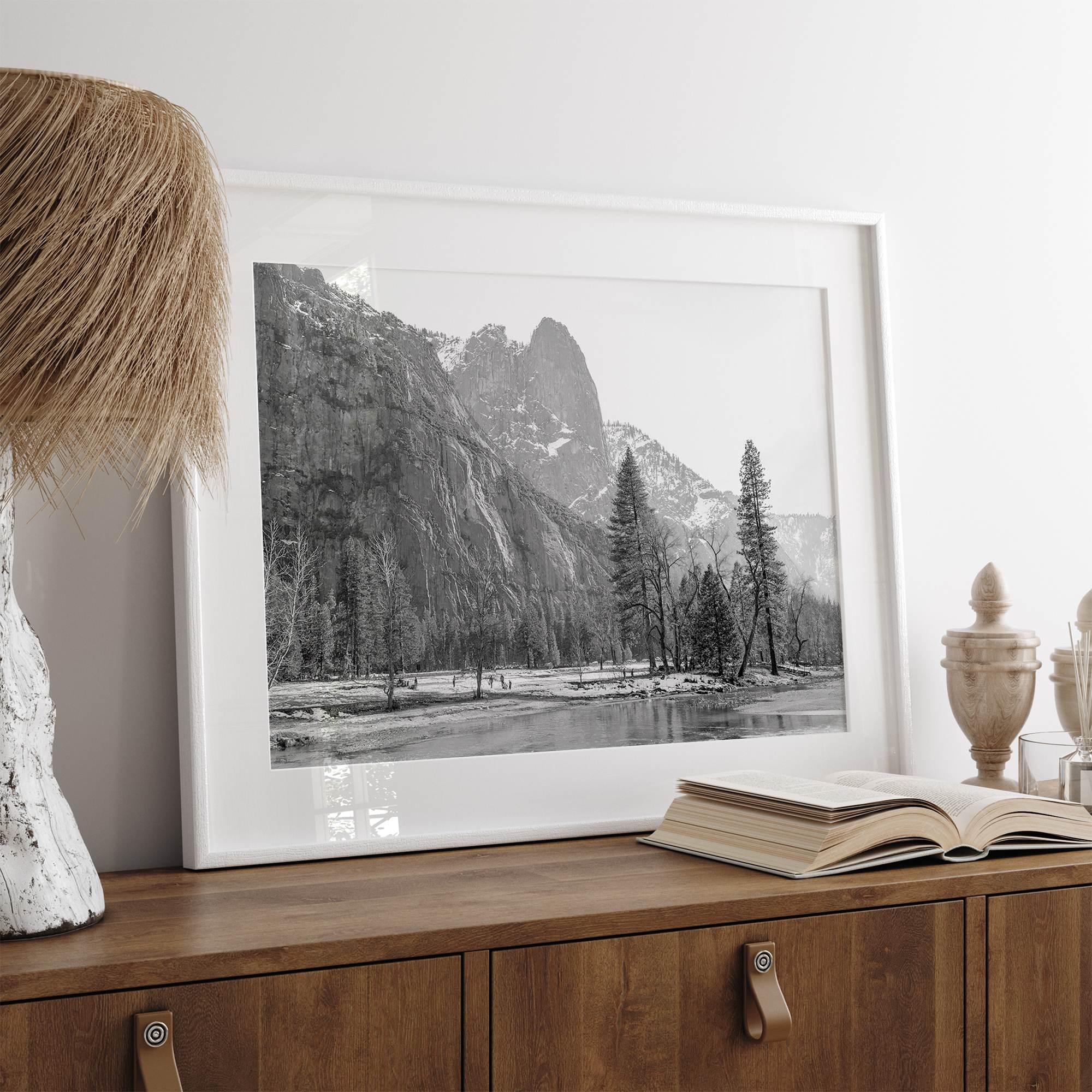 Black and white fine art print of Yosemite National Park in winter with snow-covered trees and granite cliffs.