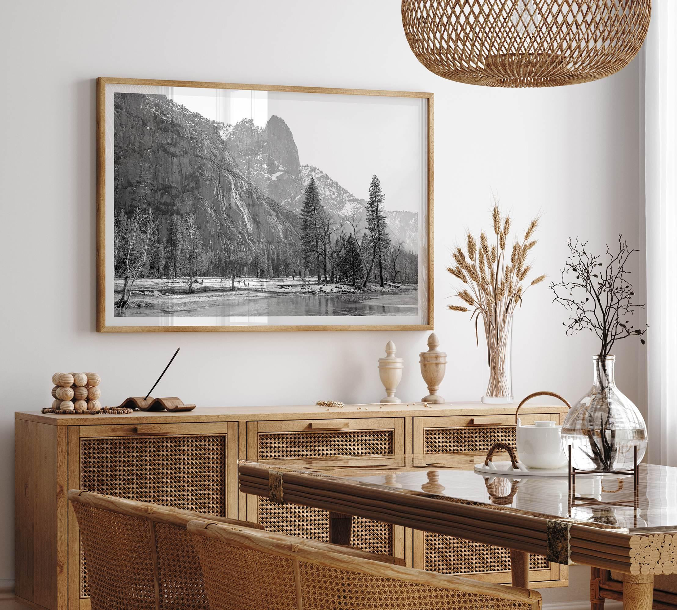 Black and white fine art print of Yosemite National Park in winter with snow-covered trees and granite cliffs.