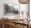 Black and white fine art print of Yosemite National Park in winter with snow-covered trees and granite cliffs.
