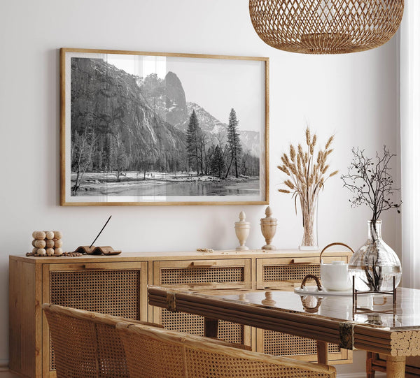 Black and white fine art print of Yosemite National Park in winter with snow-covered trees and granite cliffs.