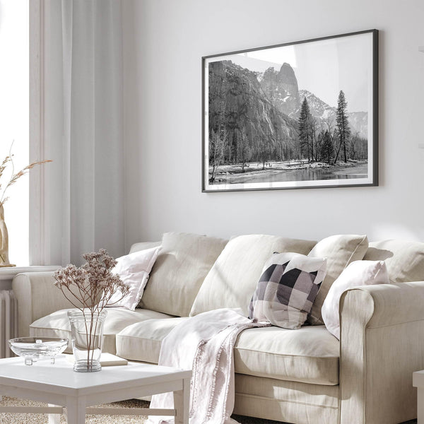 Black and white fine art print of Yosemite National Park in winter with snow-covered trees and granite cliffs.