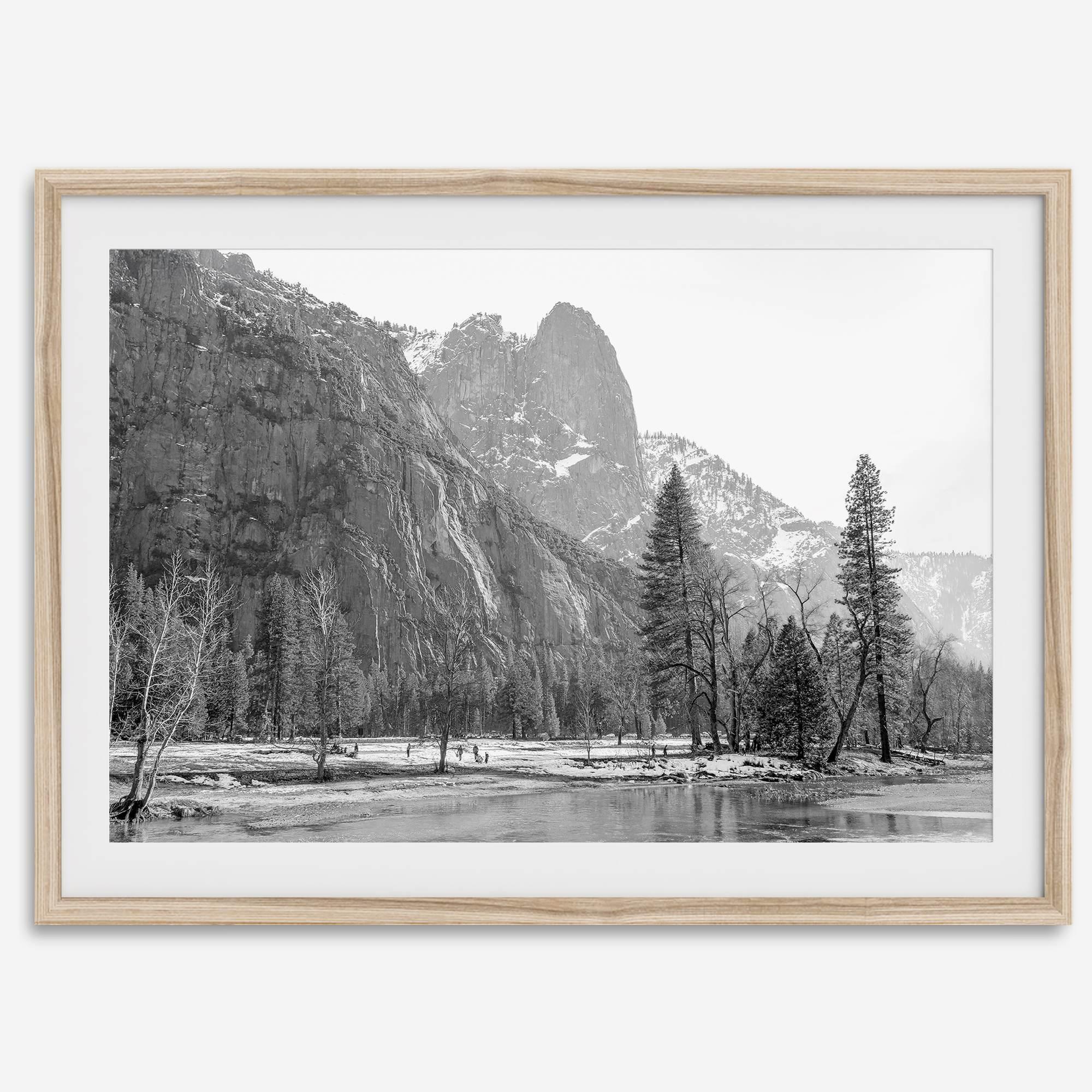 Black and white fine art print of Yosemite National Park in winter with snow-covered trees and granite cliffs.