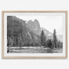 Black and white fine art print of Yosemite National Park in winter with snow-covered trees and granite cliffs.