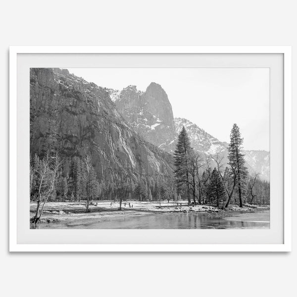 Black and white fine art print of Yosemite National Park in winter with snow-covered trees and granite cliffs.
