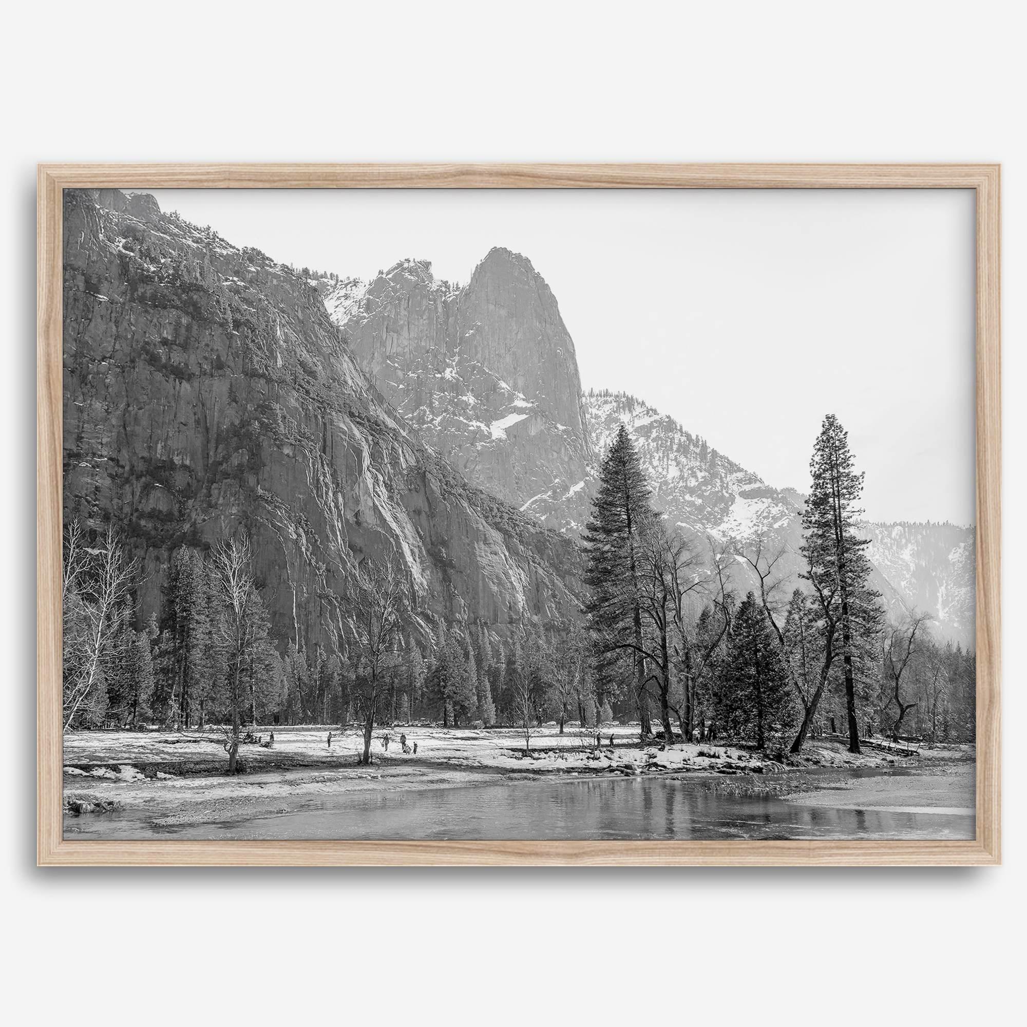 Black and white fine art print of Yosemite National Park in winter with snow-covered trees and granite cliffs.