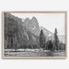 Black and white fine art print of Yosemite National Park in winter with snow-covered trees and granite cliffs.