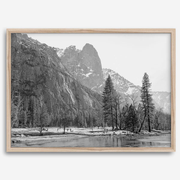 Black and white fine art print of Yosemite National Park in winter with snow-covered trees and granite cliffs.
