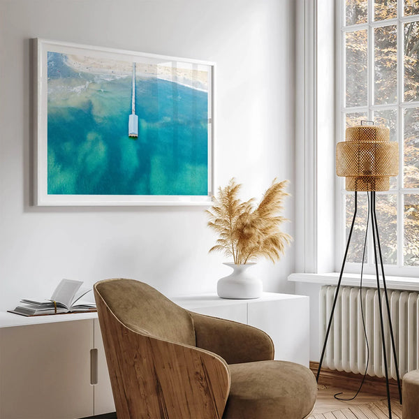 Drone photo of a pier extending into clear blue ocean at Hanalei Beach, Kauai, Hawaii.