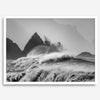 Black and white crashing waves wall art with dramatic ocean spray, jagged cliffs, and a moody atmosphere.