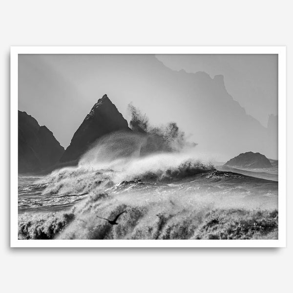 Black and white crashing waves wall art with dramatic ocean spray, jagged cliffs, and a moody atmosphere.