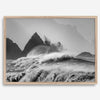 Black and white crashing waves wall art with dramatic ocean spray, jagged cliffs, and a moody atmosphere.
