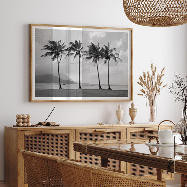 Black and white Hanalei Beach wall art featuring four palm trees with a coastal Kauai backdrop.