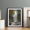 Black and white minimalist fine art print of Yosemite National Park. Sunlight filters through green leaves, revealing a hint of a cascading waterfall.