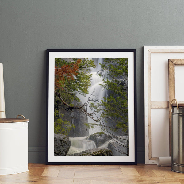 Black and white minimalist fine art print of Yosemite National Park. Sunlight filters through green leaves, revealing a hint of a cascading waterfall.