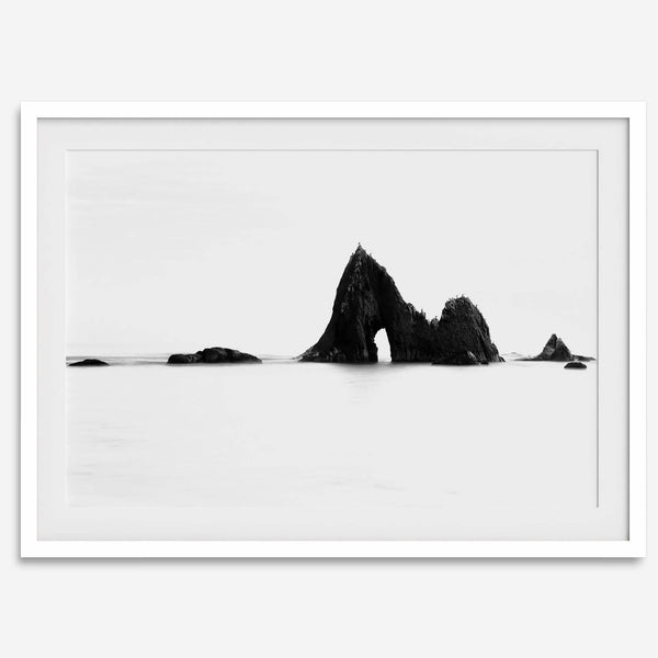 Black and white minimalist seascape print featuring a dramatic ocean arch along California’s Highway 1, perfect for modern coastal wall art.