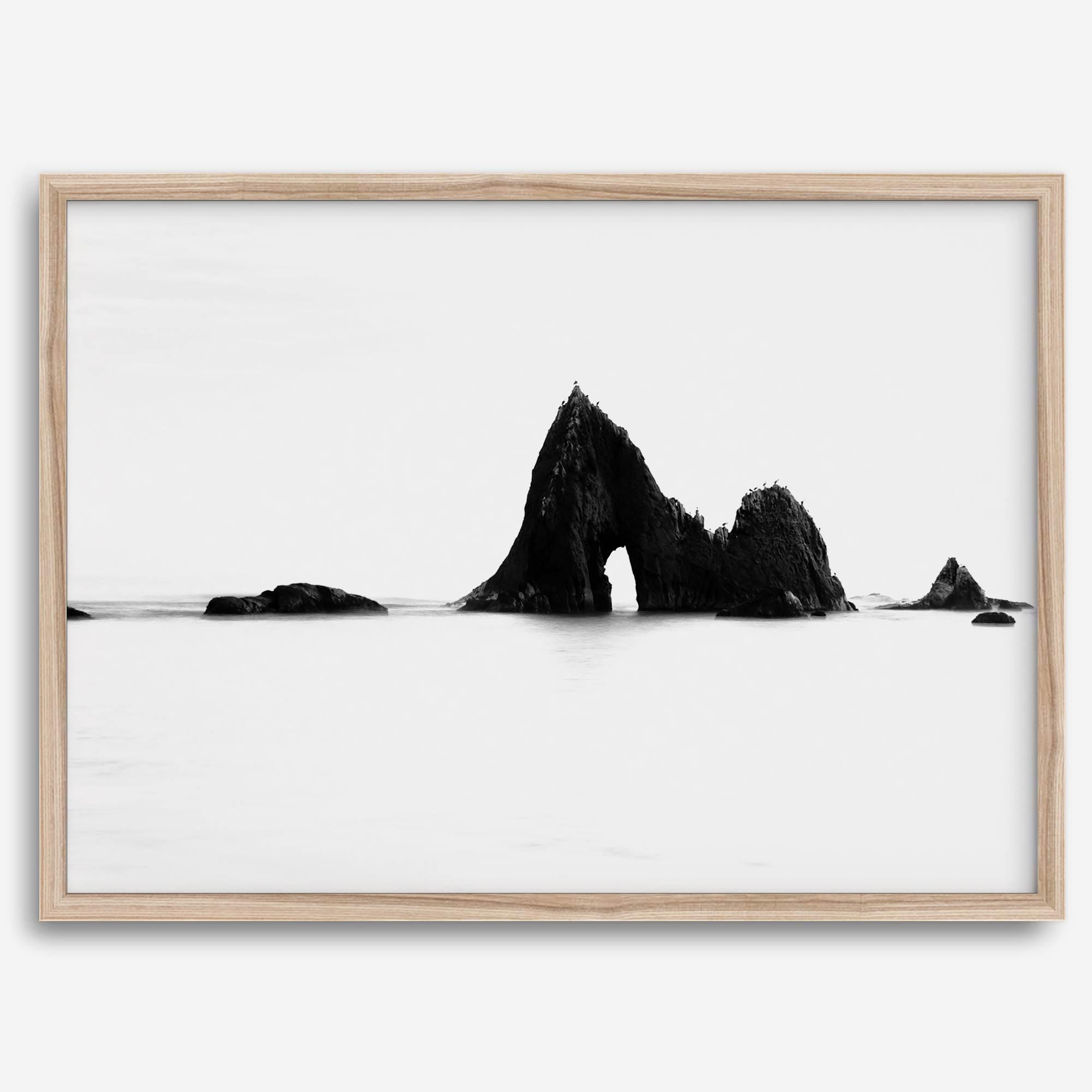 Black and white minimalist seascape print featuring a dramatic ocean arch along California’s Highway 1, perfect for modern coastal wall art.