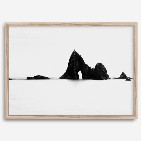 Black and white minimalist seascape print featuring a dramatic ocean arch along California’s Highway 1, perfect for modern coastal wall art.