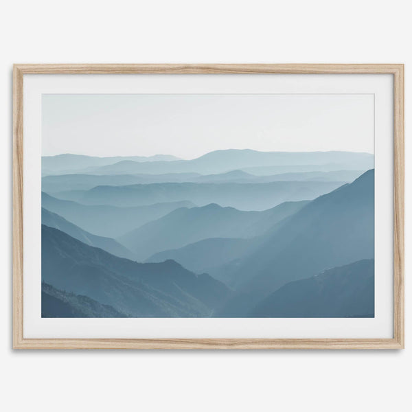 A fine art mountain photography print showing tens of shaded mountains one after the other. This minimalist mountain range wall art is perfect for nature lovers.