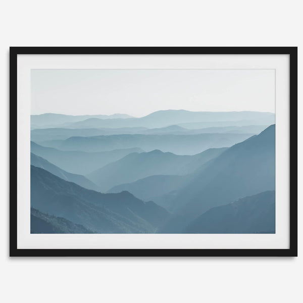 A fine art mountain photography print showing tens of shaded mountains one after the other. This minimalist mountain range wall art is perfect for nature lovers.