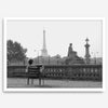 Black-and-white Paris wall art featuring a woman reading in a park with the Eiffel Tower in the background.