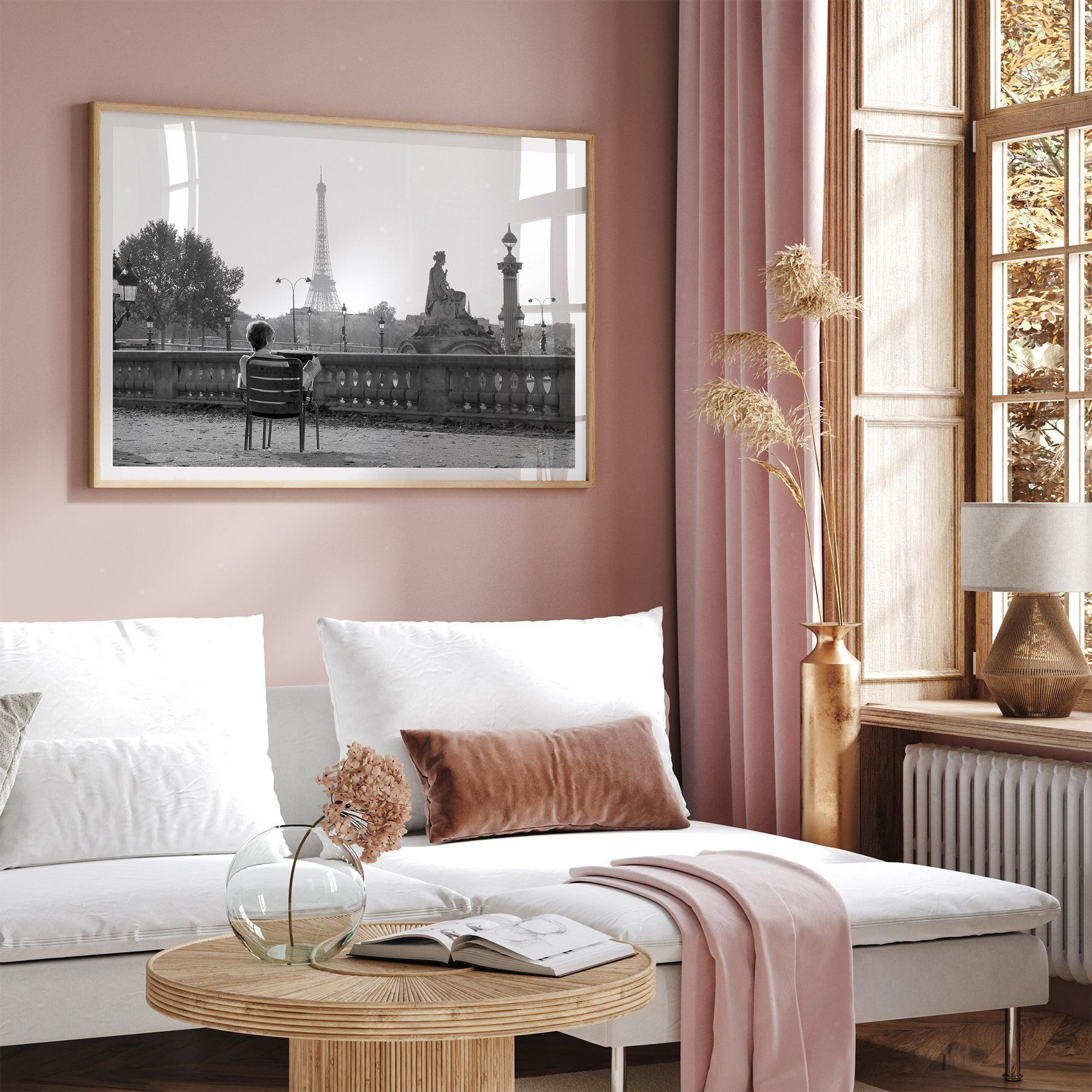 Black-and-white Paris wall art featuring a woman reading in a park with the Eiffel Tower in the background.