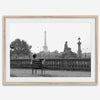 Black-and-white Paris wall art featuring a woman reading in a park with the Eiffel Tower in the background.
