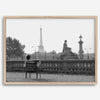 Black-and-white Paris wall art featuring a woman reading in a park with the Eiffel Tower in the background.