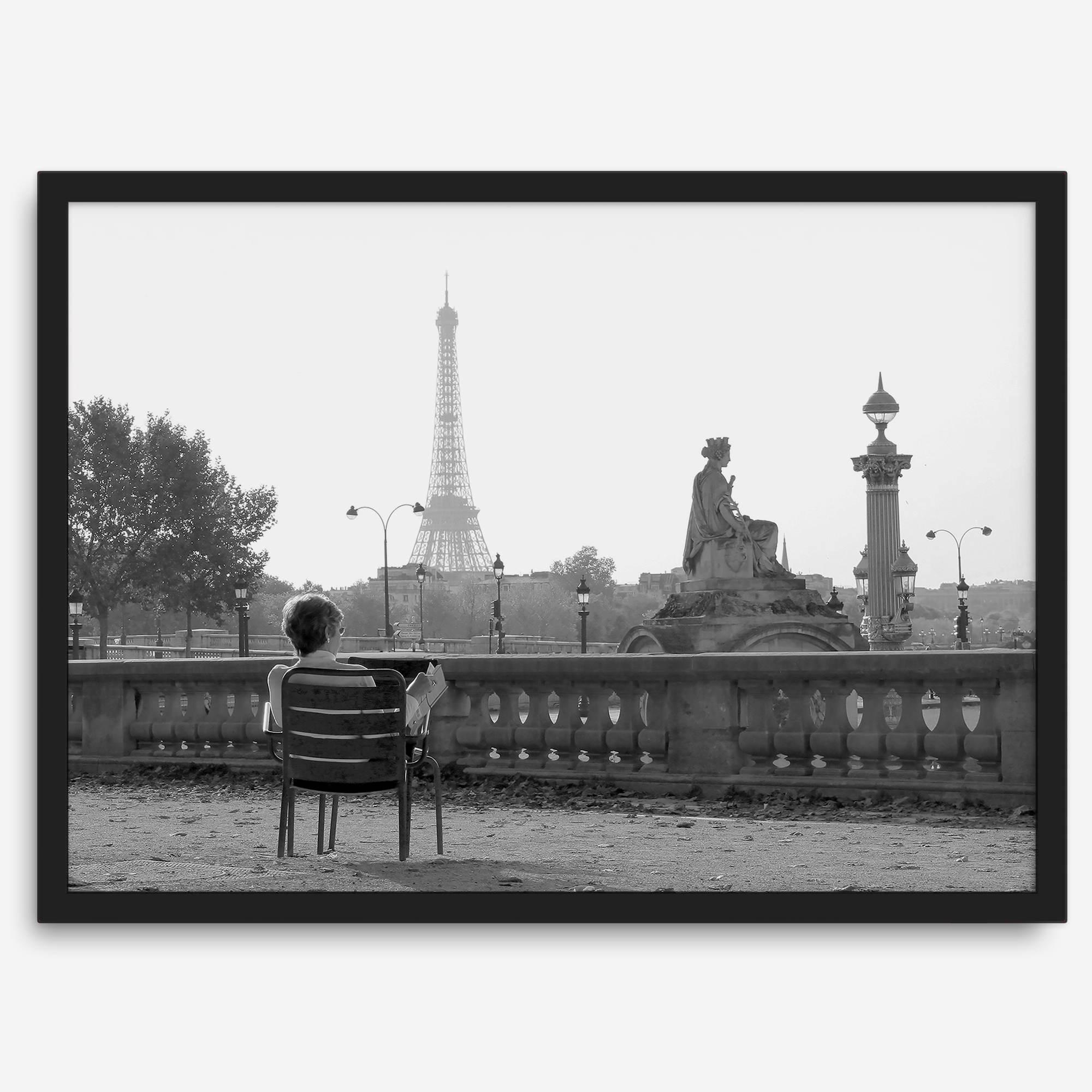 Black-and-white Paris wall art featuring a woman reading in a park with the Eiffel Tower in the background.