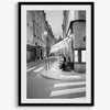 Paris street photography showing glowing café at dusk on Rue de l’Université in black and white.