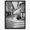 Paris street photography showing glowing café at dusk on Rue de l’Université in black and white.
