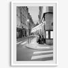 Paris street photography showing glowing café at dusk on Rue de l’Université in black and white.