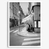 Paris street photography showing glowing café at dusk on Rue de l’Université in black and white.