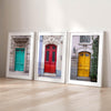 Colorful three piece wall art featuring bold architectural doors in red, teal, and yellow tones.