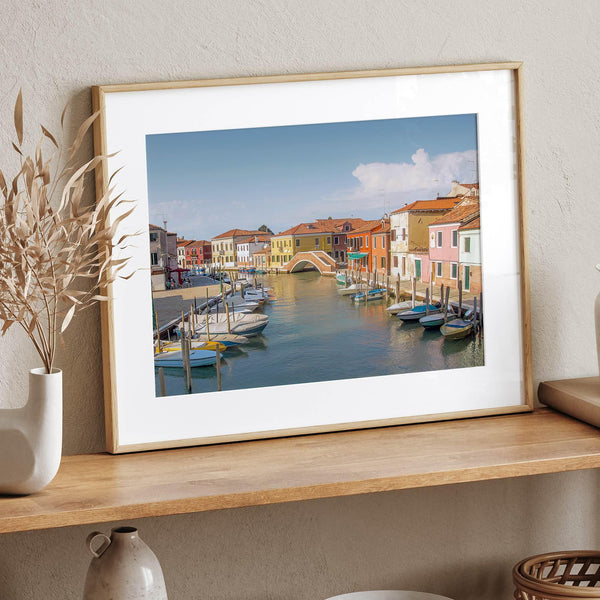 Colorful Murano Venice wall art featuring boats, bridge, and painted homes along the water.