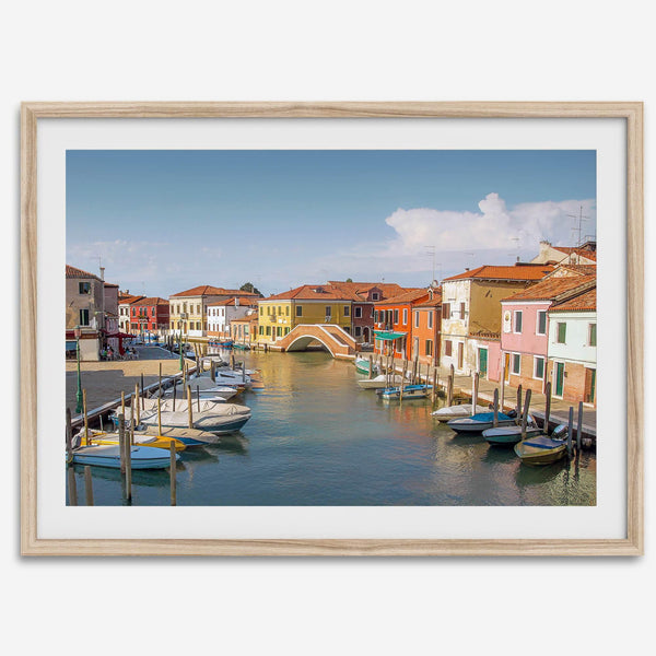 Colorful Murano Venice wall art featuring boats, bridge, and painted homes along the water.