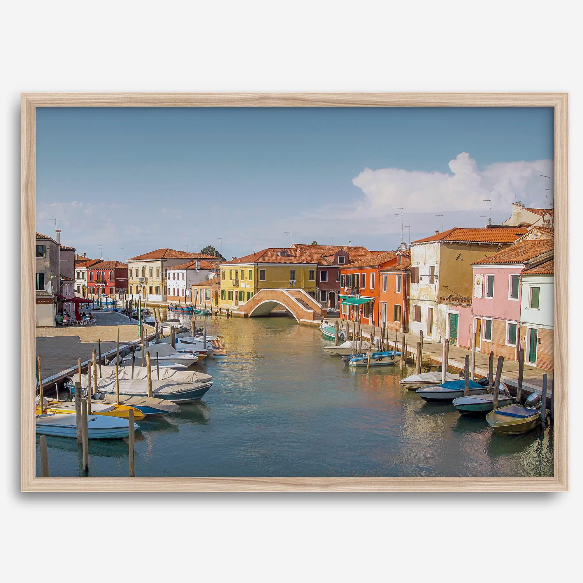 Colorful Murano Venice wall art featuring boats, bridge, and painted homes along the water.