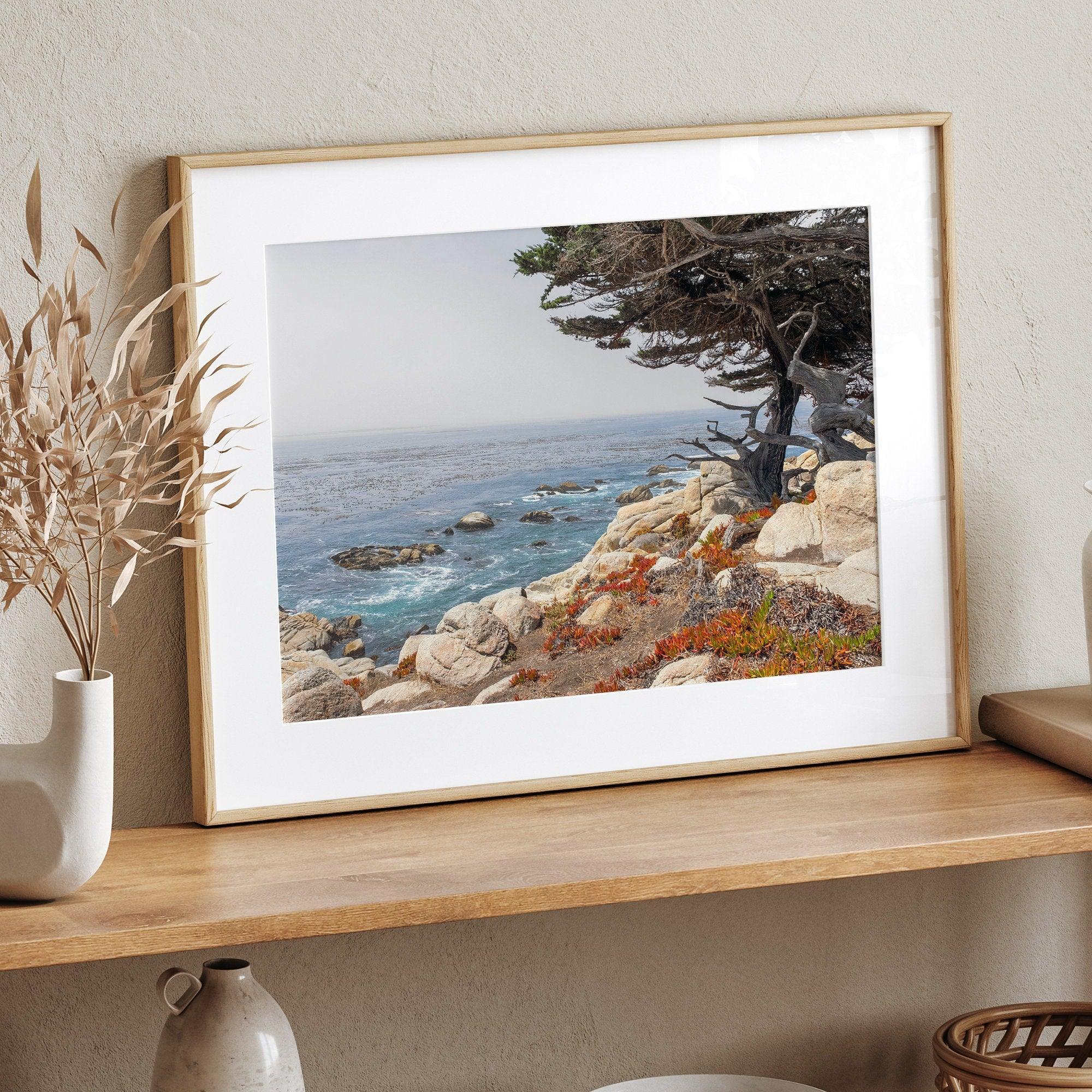 This stunning piece of art captures the beauty and drama of California's rugged coastline. This large framed or unframed ocean wall art showcases a large coastal tree overlooking the ocean near Monterey on Route 1.