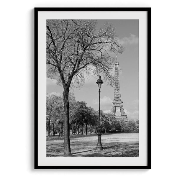 A wall art set of 2 prints from Paris. Left print - Eiffel Tower from Jardin de la Tour Eiffel. Right print - couple sitting in front of the fountain in Palais Royal Garden.