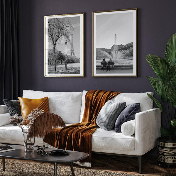 A wall art set of 2 prints from Paris. Left print - Eiffel Tower from Jardin de la Tour Eiffel. Right print - couple sitting in front of the fountain in Palais Royal Garden.